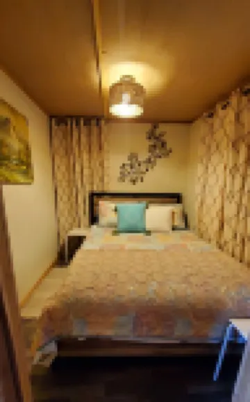 Cozy tiny cabin nested in the trees in a lake community, peaceful countryside.