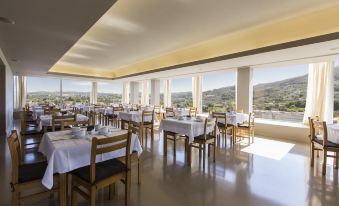 a large dining room with tables and chairs arranged for a group of people to enjoy a meal at Hotel Fundador