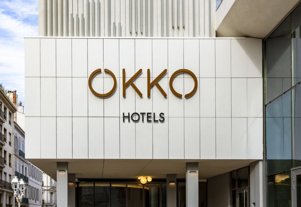"a large white building with a sign that reads "" okko hotels "" prominently displayed on the front" at Okko Hotels Toulon Centre