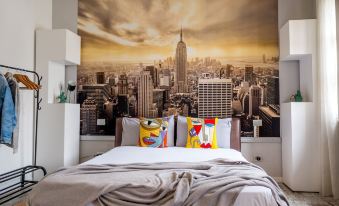a modern bedroom with a large city skyline mural on the wall , creating a unique and eye - catching atmosphere at Nest
