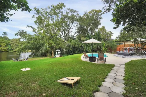 Mid-Century Boho Chic home with Pool, Game Room & Outdoor Playhouse.