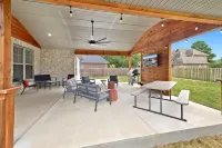 Outdoor Patio with TV and Fire Pit for Relaxation - Charming Oasis