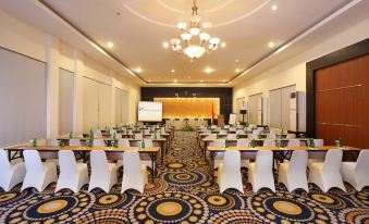 a large conference room with rows of chairs and tables set up for a meeting or event at Swiss-Belhotel Silae Palu