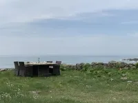 A house with the ocean at the end of the garden