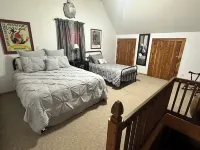 Cozy Cabin setting behind a 1 1/2 acre pond that is lined with Cypress Trees.