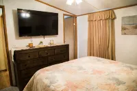 Lake front retreat, covered boat dock, large deck , fenced play area, RV parking