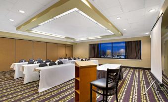 a large conference room with multiple tables and chairs arranged for a meeting or event at La Quinta Inn & Suites by Wyndham Springfield MA