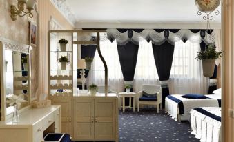 a luxurious hotel room with blue carpet , white curtains , and a black and white striped rug at Green House
