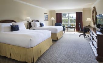 a hotel room with two beds , white linens , and a view of the city through large windows at Lafayette Park Hotel & Spa