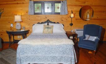 a cozy bedroom with a wooden bed , blue curtains , and a rug on the floor at River Valley Rentals