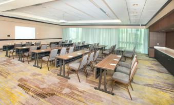 a conference room with wooden tables and chairs , curtains on the windows , and a rug on the floor at Courtyard Redwood City