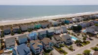 4BR beach getaway steps away from the beach with community pool