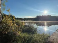 Serene cottage on private lake! Enjoy a private dock, fire pit, canoe, & more!