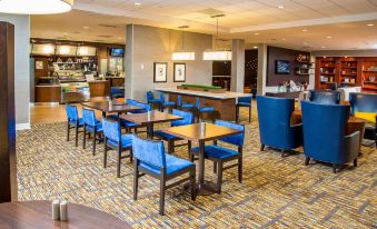 a large dining room with multiple tables and chairs , creating an inviting atmosphere for guests at Courtyard by Marriott Los Angeles Pasadena/Monrovia
