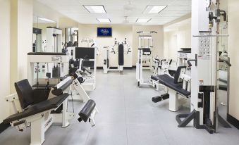 a well - equipped gym with a variety of exercise equipment , including weight machines and free weights at Peabody Memphis