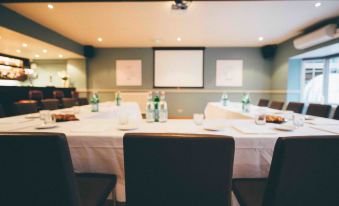 a conference room set up for a meeting , with several chairs arranged around a table at The Blue Boar