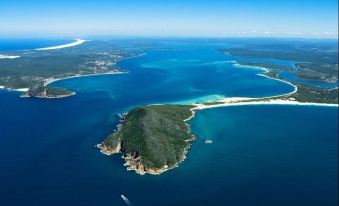 a bird 's eye view of a body of water with several islands and boats in the distance at Reflections Jimmys Beach - Holiday Park