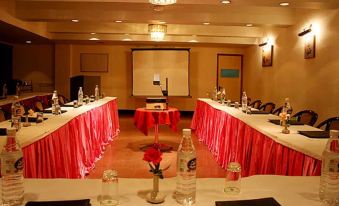 a conference room set up for a meeting , with tables and chairs arranged in rows at Apple Valley Resort