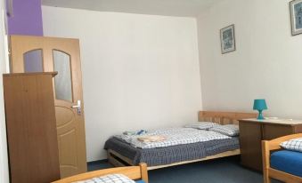 a small room with three beds , two of which are on the left side of the room and one on the right side at Bike Apartment