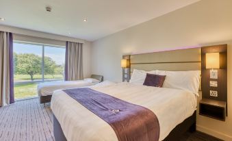 a hotel room with two beds , one on the left and one on the right side of the room at Premier Inn Bangor (Northern Ireland)