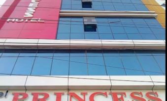 "a tall building with a pink sign that reads "" princess "" and other words such as "" mother 's "" and "" guest .""." at Hotel Princess