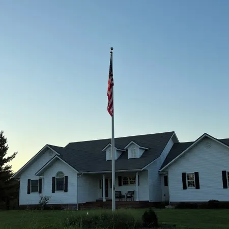 Fully custom modern four bedroom home on 13 acres with a stocked pond.