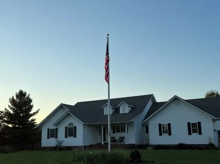 Fully custom modern four bedroom home on 13 acres with a stocked pond.