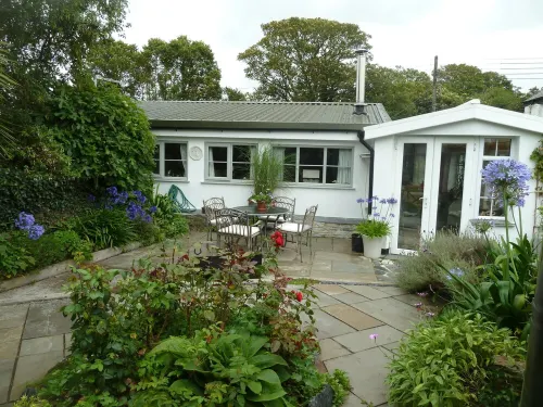 Quirky home with romantic shepherds' hut bedrooms and pretty garden near Padstow