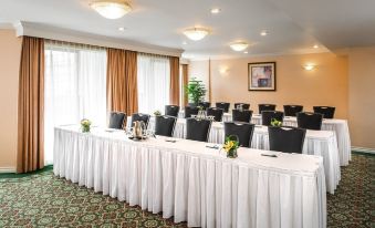 a conference room set up for a meeting , with tables and chairs arranged in a semicircle at Hotel Grand Pacific