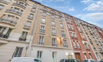 a city street with a tall building on the left side and a smaller building on the right side at Paris Hotel