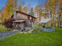 Cabin rental with Hot Tub, Fire Pit, mini fountain pond, hammocks, corn hole.