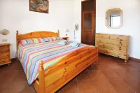 Large apartment with covered outdoor patio with table and barbecue.