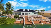 Waterfront Home with a Large Dock, Pool, and Deck Area. Can Accommodate Pets.