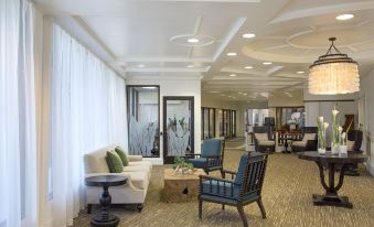 a spacious living room with various furniture , including a couch , chairs , and a dining table at OUTRIGGER Kaua'i Beach Resort & Spa