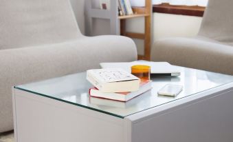 a living room with two white couches and a glass coffee table on the floor at Aries