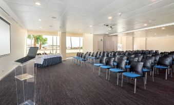 a conference room with rows of chairs arranged in a semicircle , ready for a meeting or presentation at AP Maria Nova Lounge