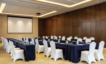 a conference room set up for a meeting , with several chairs arranged in rows and a projector on the wall at Pullman Changbaishan Resort