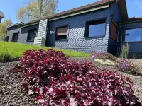 Vacation cottage garden view directly at the forest & spa gardens