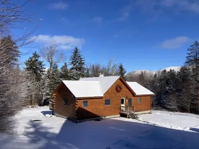 Experience the rustic charm of a log cabin chalet nestled on 14 private acres.