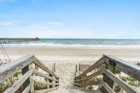 Beachfront 2-bedroom townhome, private beach access, outdoor space & amenities.