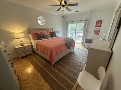 Nestled amidst lush greenery The 5 Bedroom Pink House offers a serene getaway.