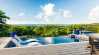 Tiny house on an acre with ocean view and private infinity pool.