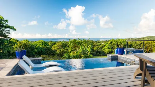 Tiny house on an acre with ocean view and private infinity pool.