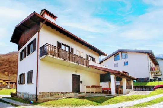 Large apartment with covered outdoor patio with table and barbecue.