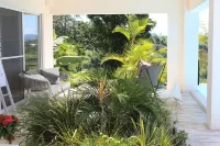 Luxurious villa set in a vast tropical garden, with panoramic sea and nature views.