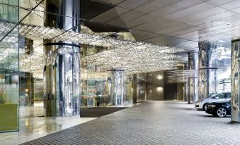 The main building has a lobby with two large glass doors for entrance at The Kowloon Hotel