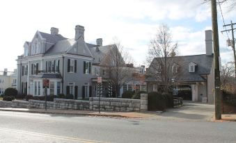 a street view of a brick house with a tree and a gate in front at Residence Inn Waynesboro