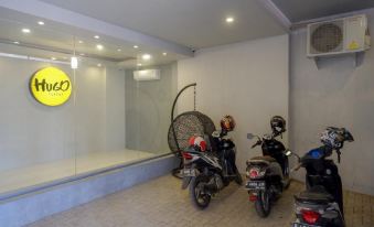 "a modern storefront with a sign that says "" nom "" and three motorbikes parked inside , along with the sun visible through the glass window" at RedDoorz Syariah @ Jalan Sultan Agung Tegal