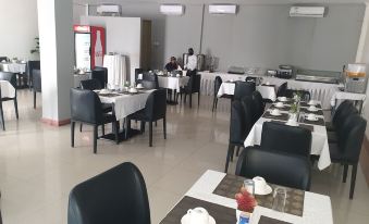 a large dining room with tables and chairs arranged for a group of people to enjoy a meal together at Hotel Oceano