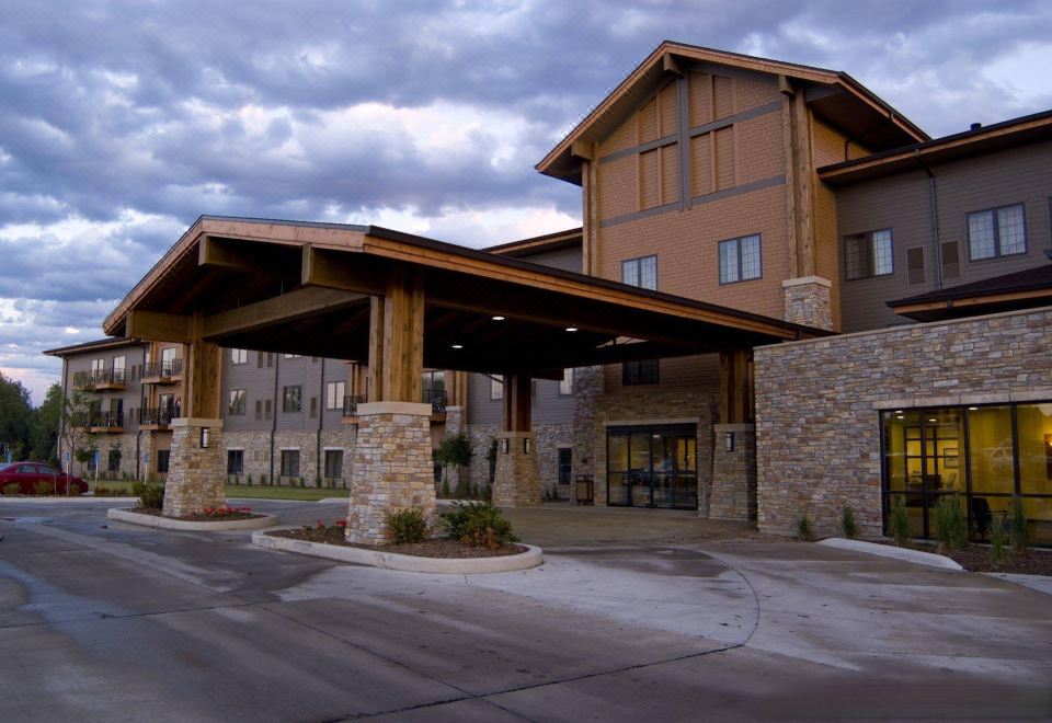 an exterior view of a hotel or resort , with a large building in the background at King's Pointe Waterpark Resort